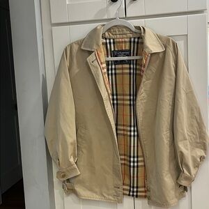 Iconic Burberry Lined Trench with adjustable buckles at sleeves and waist.